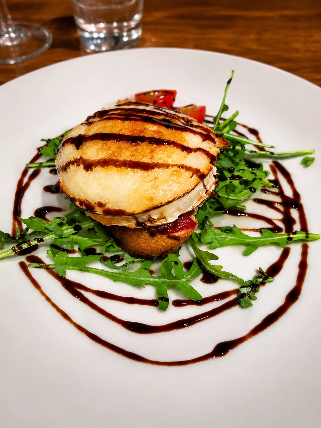 Baked cheese starter with rocket and balsamic dressing